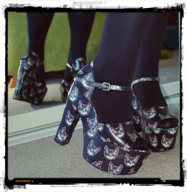 wearing platform shoes with cat face print on uppers