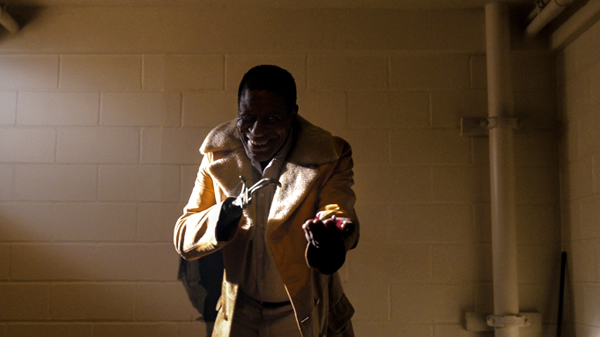 A stranger with a hook for a hand offers treats in 2021's CANDYMAN.