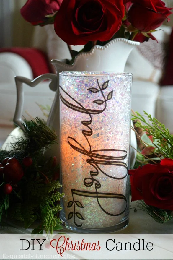 DIY Christmas Glitter Candle words on photo of Joyful glitter candle on table with Christmas greenery