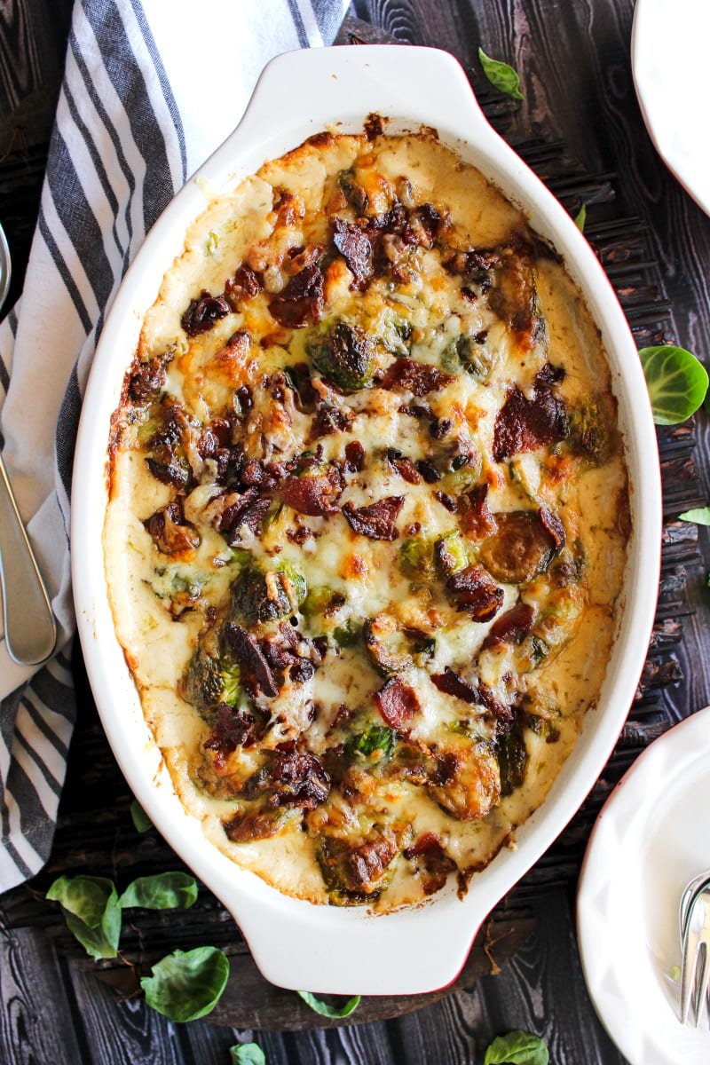This Brussels Sprouts and Bacon Casserole is loaded with crumbled bacon and smothered in a luscious cheese sauce. It's the perfect holiday side dish! #brusselssprouts #casserole #sidedish