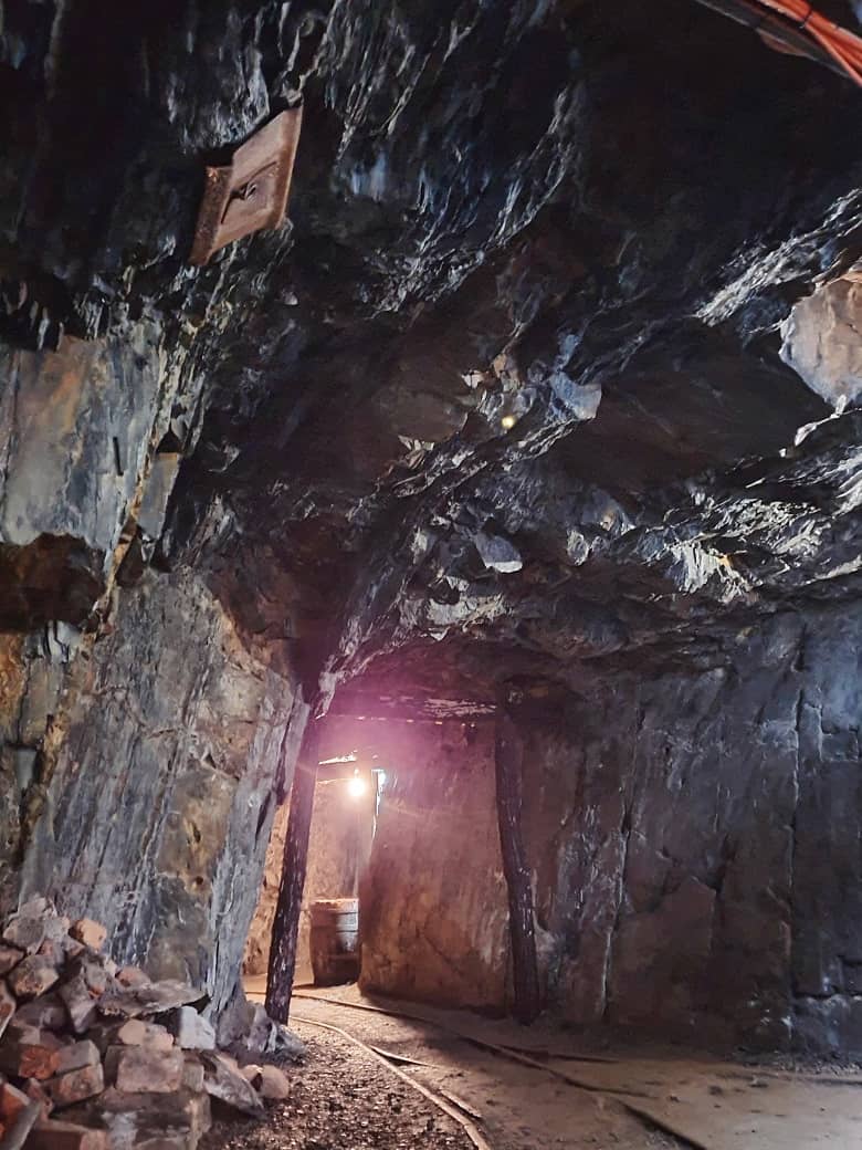 A picture inside the gold mine containing rock, stone, trunk