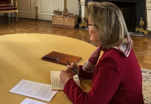 Queen Mathilde in jazzberry wine-red blazer from Stella McCartney. Max Mara double-breasted blazer. Silk with a pattern scarf from Giorgio Armani