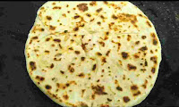 Crisp golden brown onion kulcha on tawa or pan