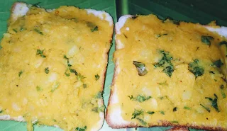 Spreading potato mixture over the bread slices for bread pakora recipe