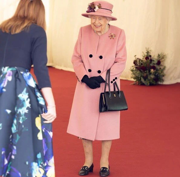 Queen Elizabeth wore a pink coat by Stewart Parvin and matching hat by Rachel Trevor-Morgan. Carved Ruby, gold and diamond brooch, Grima ruby brooch