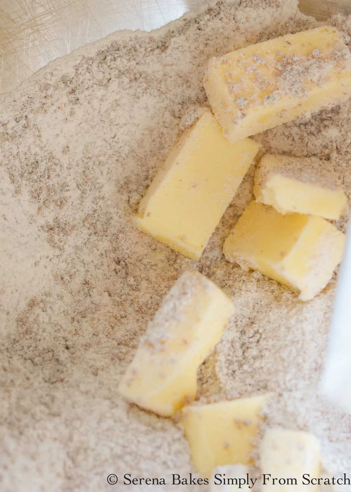 Cold butter added to flour and sugar mixture.