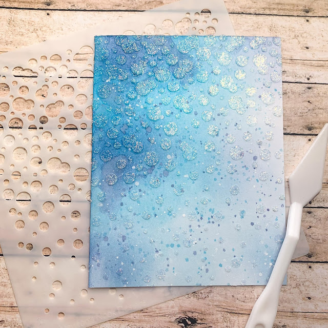 February Guest Designer Caitlin Anthony creates a glittery background using the Bubbly Stencil by Newton's Nook Designs