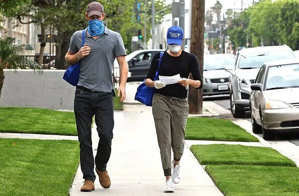 Meghan Markle wore James Perse cotton mixed media jersey trousers and Stella McCartney Adidas sneakers. Prince Harry