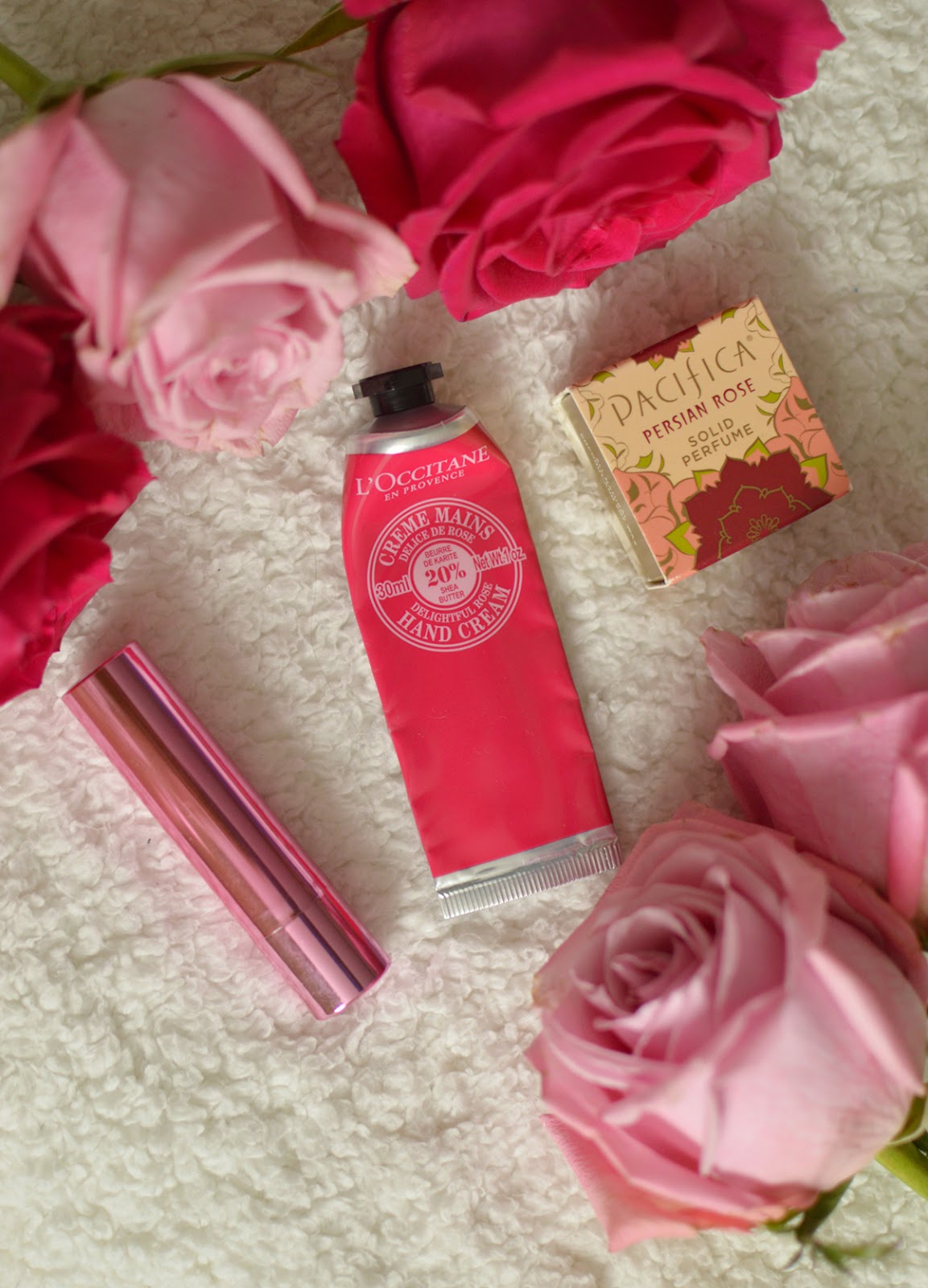 lierac lip balm, l'occitane rose hand cream, pacifica rose solid perfume