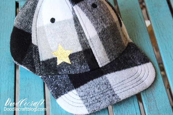 Make a Glitter Star Hat with the new Cricut EasyPress Mini in just 5 minutes. Black and White Buffalo plaid wool ball cap with gold glitter heat transfer vinyl star. Great for doll clothes, sleeves, stuffed animals and more!