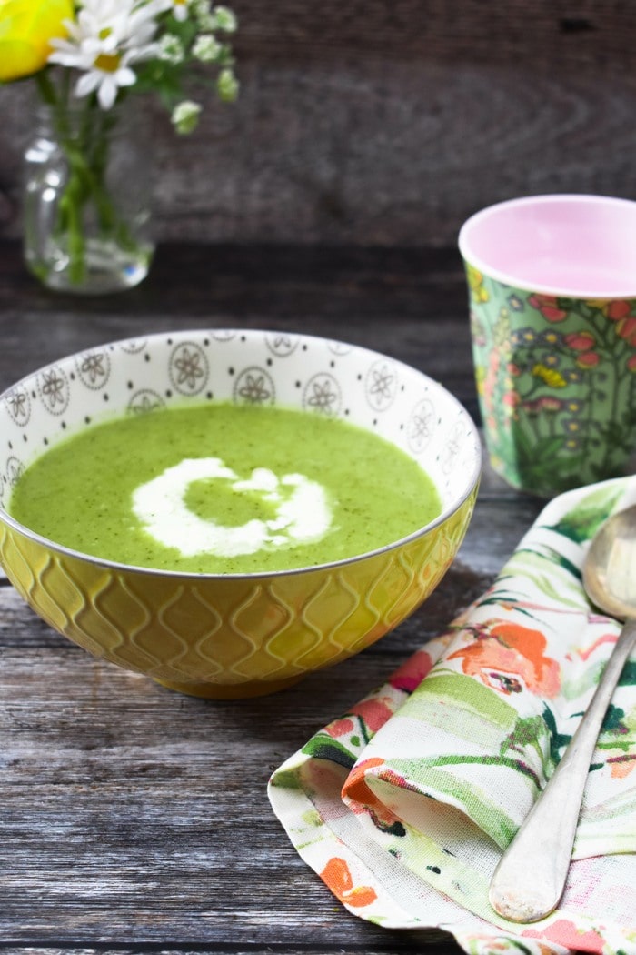 Broccoli and pea soup in a yellow bowl