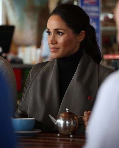 Meghan Markle wore Club Monaco Ellayne trench coat, Stuart Weitzman Veruka suede boots and Outland Denim Harriet Jeans