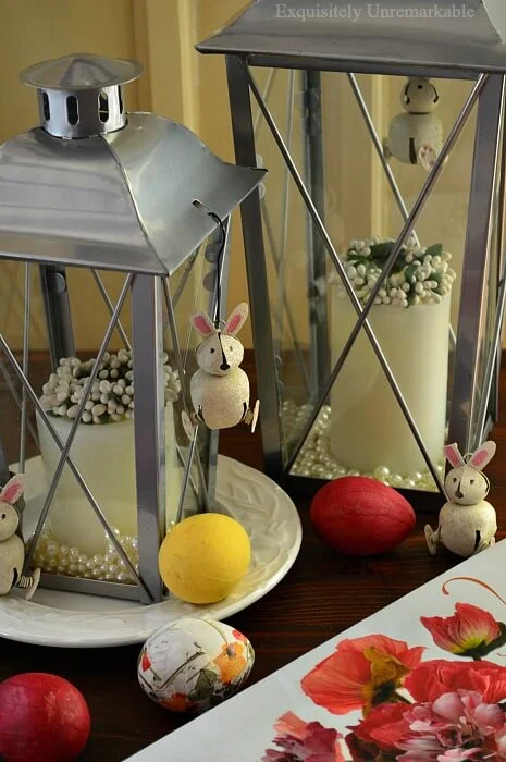 Metal Lanterns accessorized with mini wreaths, colored eggs and jingle bell bunnies for Easter