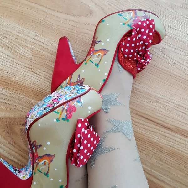 wearing Irregular Choice One Love deer print shoes with red heel and bow