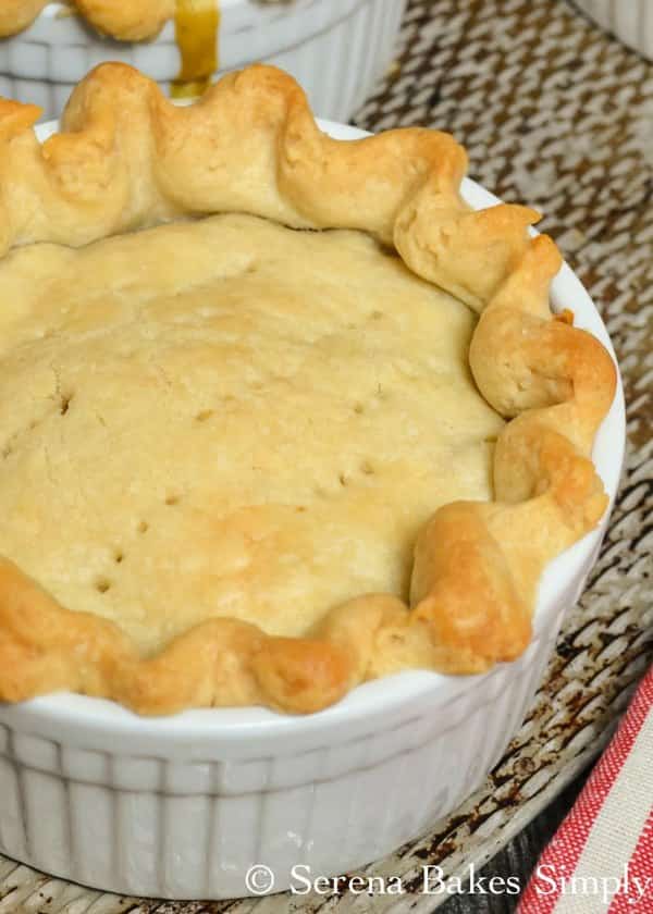 Baked Homemade Chicken Pot Pie is a comfort food classic filled with chicken, carrots, and peas in a creamy gravy and covered in a flaky pie crust from Serena Bakes Simply From Scratch.