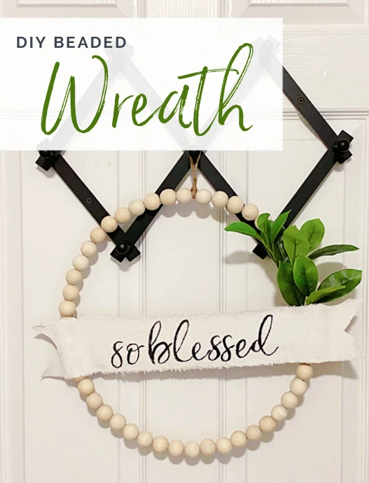 wreath hanging from pegs with overlay