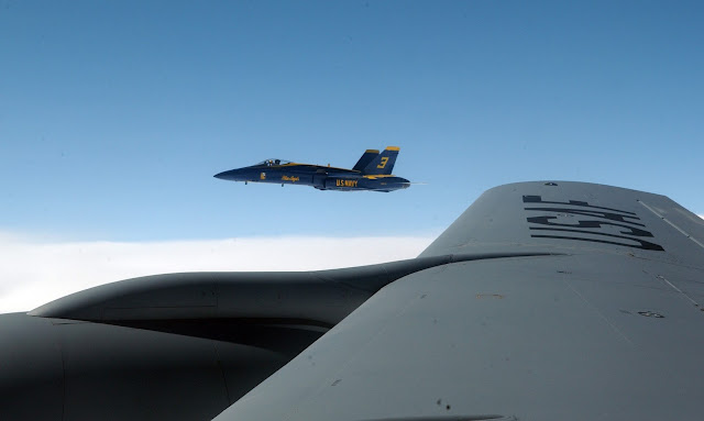 F/A-18 Hornet over the wing of  a KC-135 Stratotanker.