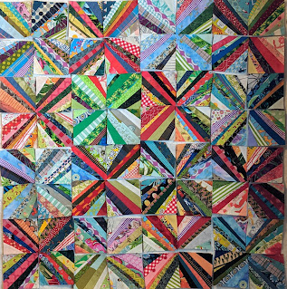 Long skinny strings of fabric in a variety of prints form Xs when set together.