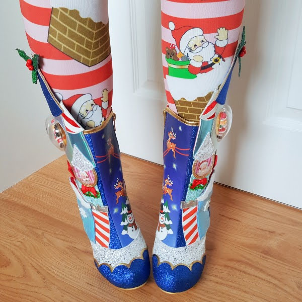 front view wearing blue festive Santa boots with striped tights