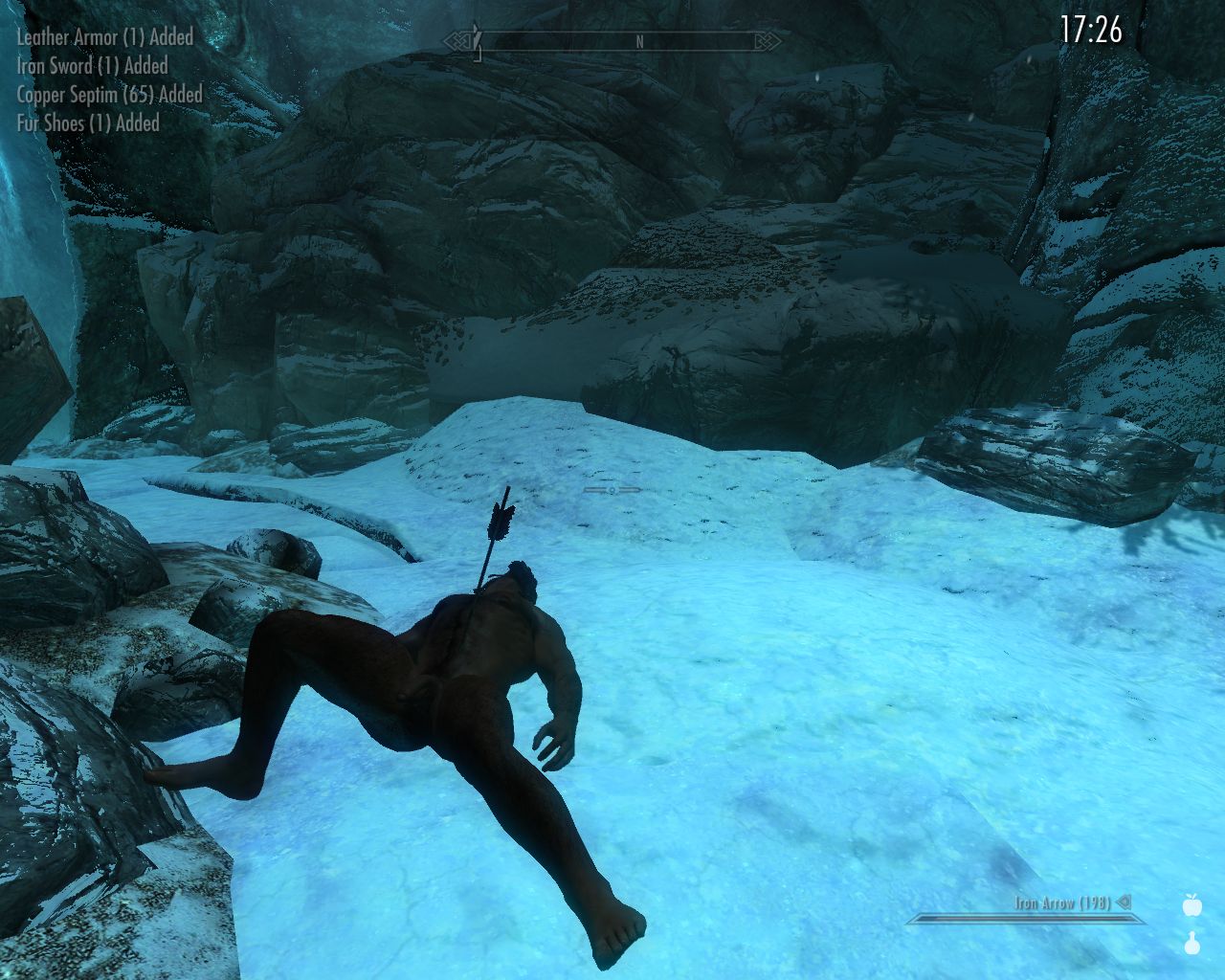 dead man with an arrow in his chest lies on icy snow in a wide rocky dungeon passage