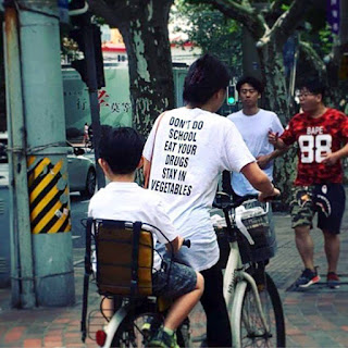 korean boy riding on child seat bike