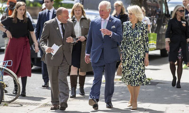 The Duchess of Cornwall wore a floral print silk dress by designer, Fiona Clare. Camilla carried for her Bottega Veneta bag