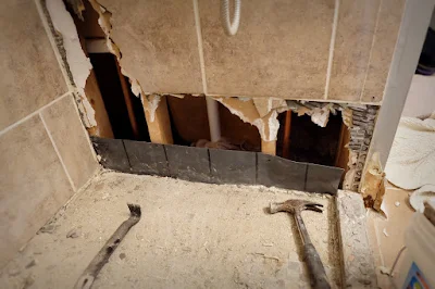 hole shower wall broken tile leak tub