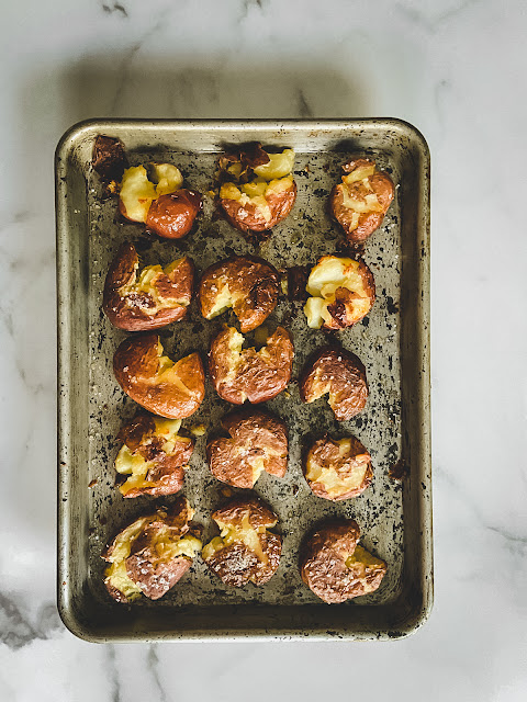 Ultra Crispy Smashed Potatoes, sweet little potatoes crispy on the outside and creamy on the inside with a generous sprinkle of coarse salt.  There is nothing complicated or fussy about them–– just easy.