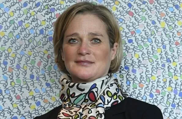 Princess Delphine of Belgium wore a black belted blazer and silk satin print scarf from Saxe-Coburg. Professor Tessa Kerre is president of the fund