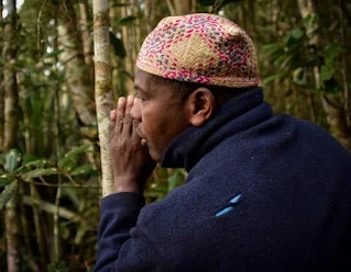 African man talking to a tree in a ritual