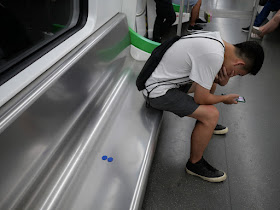 two tokens left on a subway train bench in Nanning