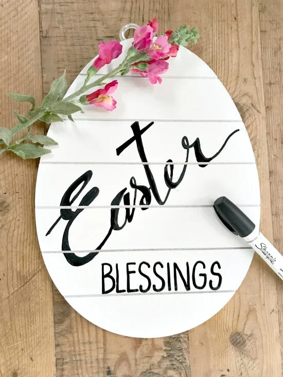Hand-painted white egg sign for Easter