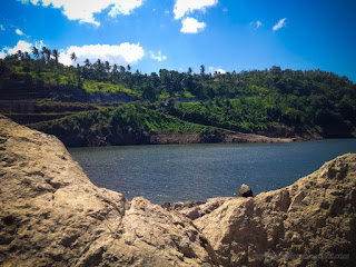 Peaceful Scenery Lake Water Dam And The Hills From Rock Excavation On A Sunny Day Titab Ularan North Bali Indonesia