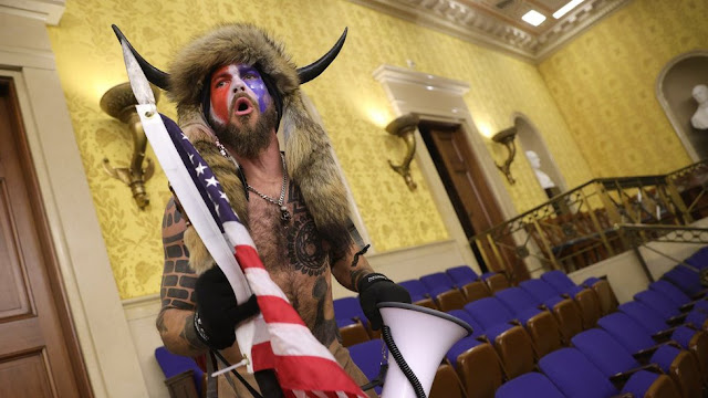 Shirtless man with an horn and a painted face during the US Capitol Riot has been arrested