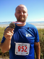 Image: Lance holding finishing medal.