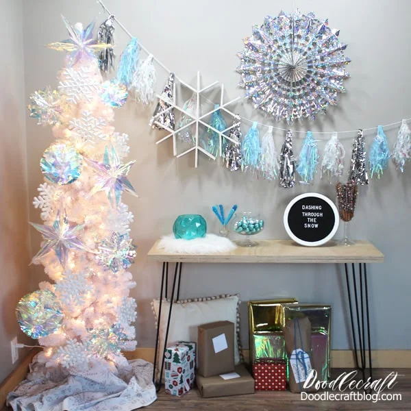 Frozen birthday party with silver and blue snowflakes, iridescent decorations, textures and lots of yummy food...plus becomes holiday decor for the Christmas tree after the party.