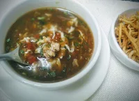 Chicken manchow soup serving with fried noodles