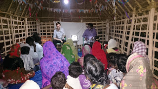 Using a laptop to show pictures to explain God's Word