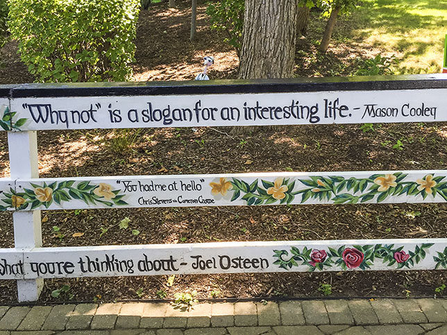 Along the Lake Geneva Lake Shore Path in Lake Geneva Wisconsin Fence hand painted with slogans and quotes