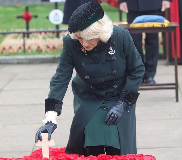 The Duchess of Cornwall wore a green wool coat at Westminster Abbey. The Duchess in a recycled green coat, and a poppy facemask
