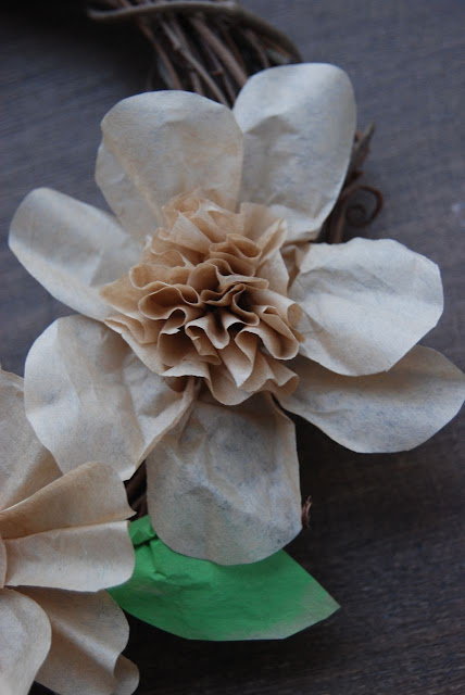 Hot glue your flower to your wreath, looking to vary the flower forms for more interest. 