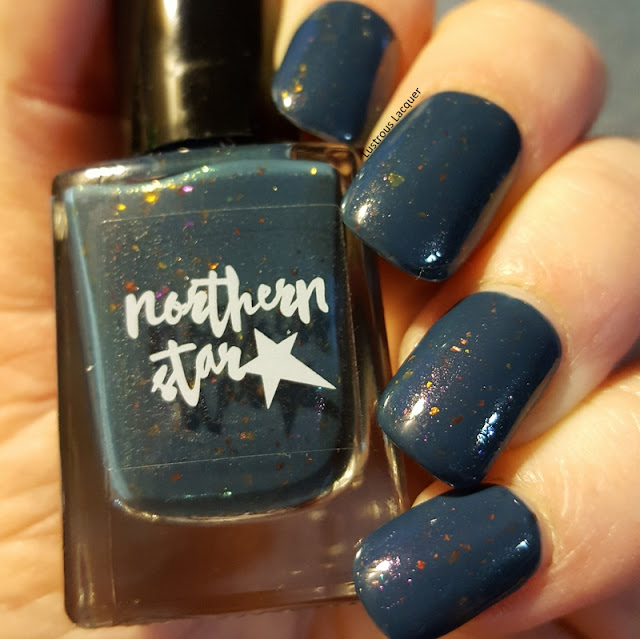 dark-blue-nail-polish-with orange-and-gold-flakes-and-pink-shimmer