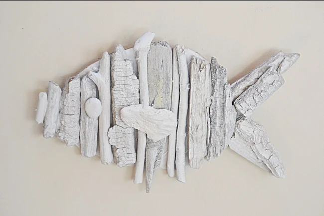 white driftwood fish hanging on the wall