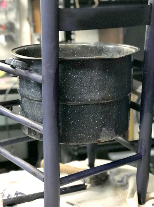 Adding an enamelware pot to a planter chair. 