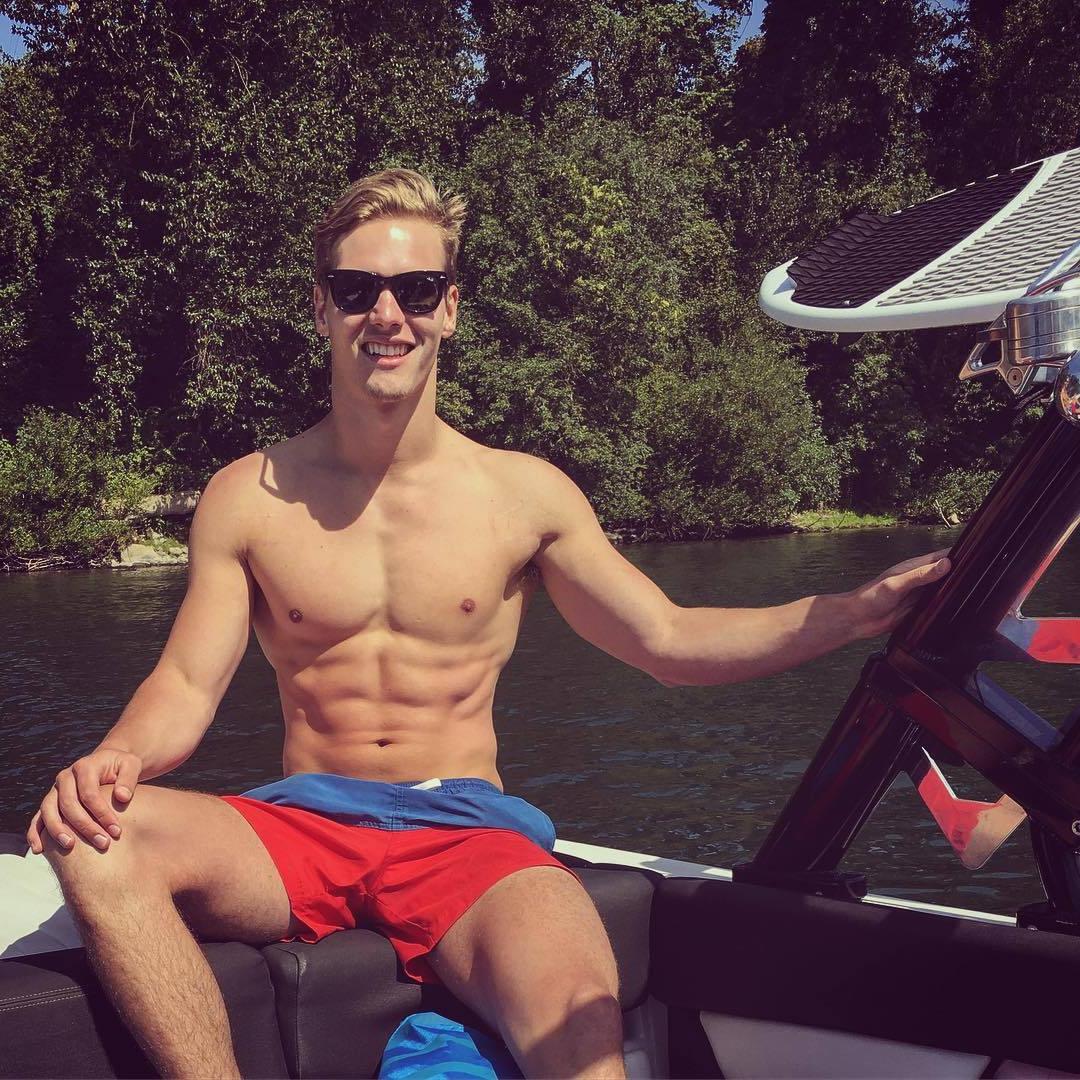 cute-blond-fit-young-teen-shirtless-boy-smiling-boat-sunglasses