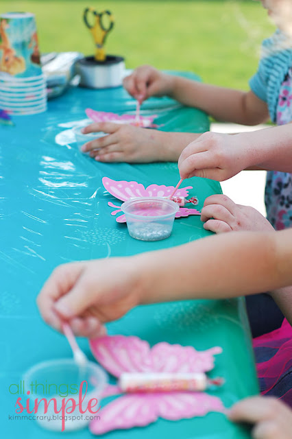 Use q-tips to spread glitter glue on the wings of this fairy party birthday party craft.