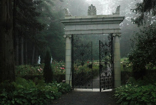 Yaddo Gardens, Saratoga Springs, NY A white marble entry way into the gardens with mist all around.