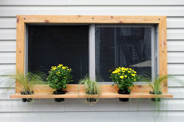 cedar floating shelf planter installed on window frame