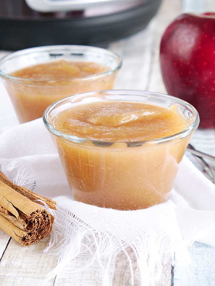 How to make applesauce in an Instant Pot. Use your Instapot to make homemade healthy applesauce with honey and cinnamon. This whole 30 no sugar recipe makes unsweetened applesauce or honey sweetened applesauce, your choice.  Make quick small batch apple sauce for baby or for adults.  You can then make canned applesauce or put it in the freezer to save for later. Freezing recipes is easier ofr his DIY home made recipes. Also gives tips for the best apples to use.  #instantpot #applesauce #apples 