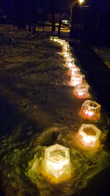 a row of ice lanterns along a walkway